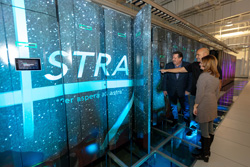 Sandia engineer and Westwind owners looking at Astra supercomputer.