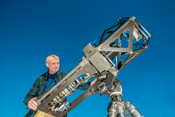 Sandia National Laboratories project lead Ted Winrow with the telescope he and his team built using advanced manufacturing techniques.