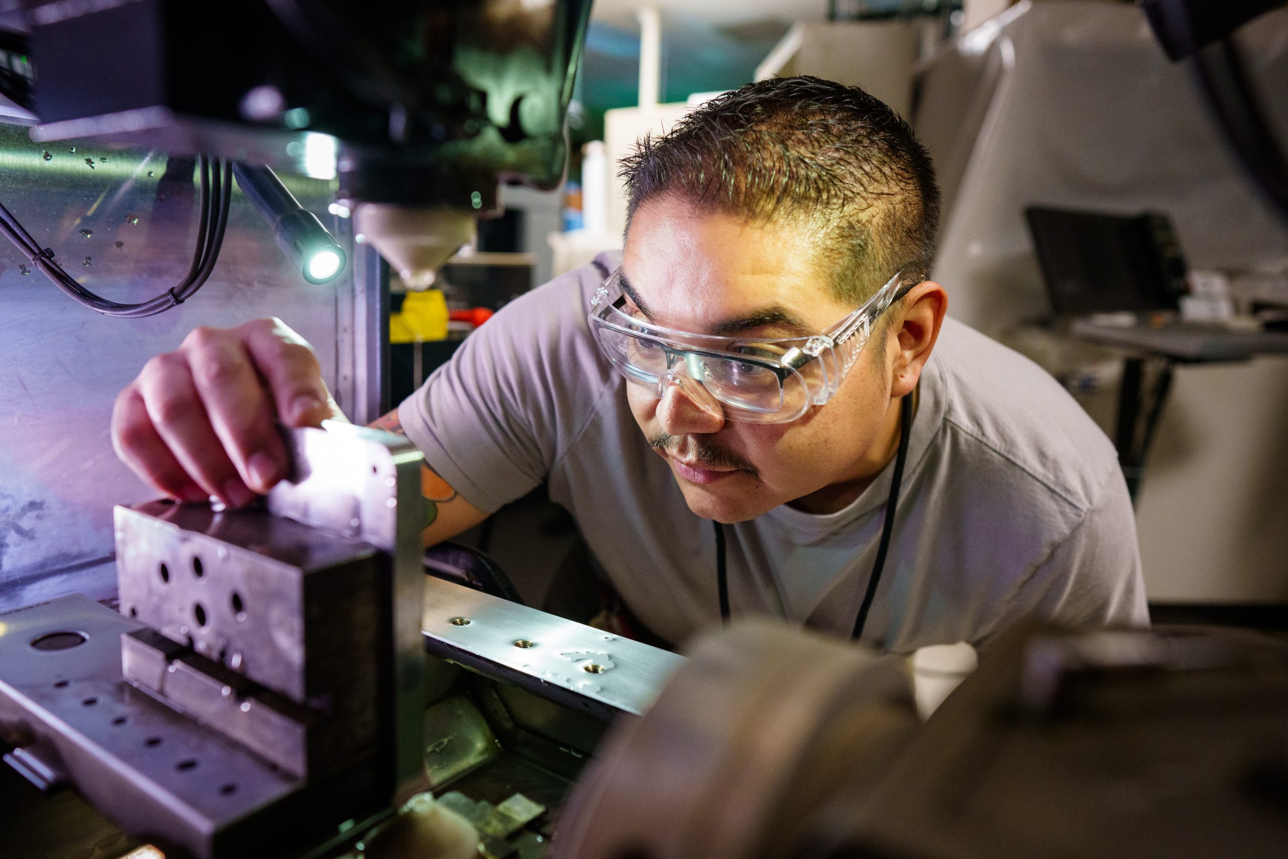 A Sandia National Laboratories machinist sets up 3D-printed metal parts for a newly designed cable connector used for testing the W80-4. The new connector is the result of collaboration across the Laboratories.