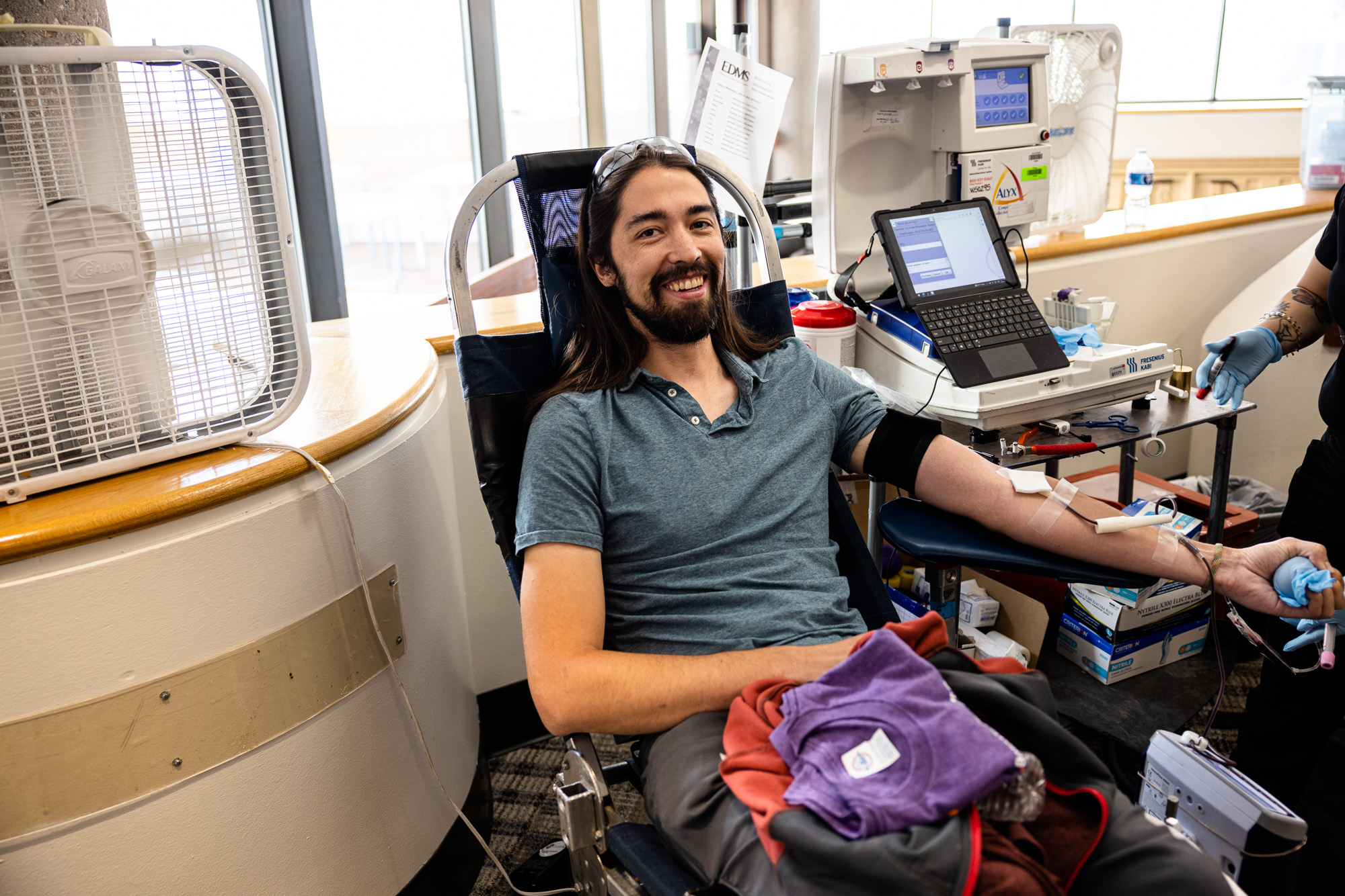 Los Alamos employee Martin Ward smiles as he gives blood that will help other New Mexicans in need.