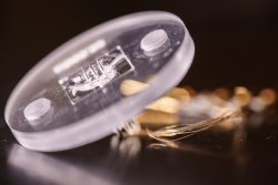 A microneedle-based sensor puck designed by Sandia National Laboratories researchers to continuously monitor the levels of a ‘last line of defense’ antibiotic with less pain than a blood draw.