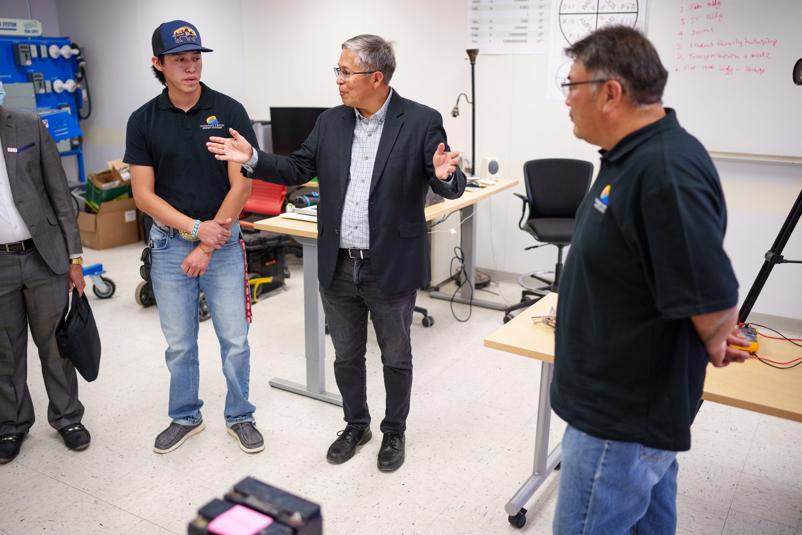 Sandia National Laboratories Senior Scientist Stan Atcitty. center, speaks during a visit to Navajo Technical University on June 30, 2023. Atcitty received an award from the Institute of Electrical and Electronics Engineers for his work with tribal nations providing information as to how they can meet their electrical needs