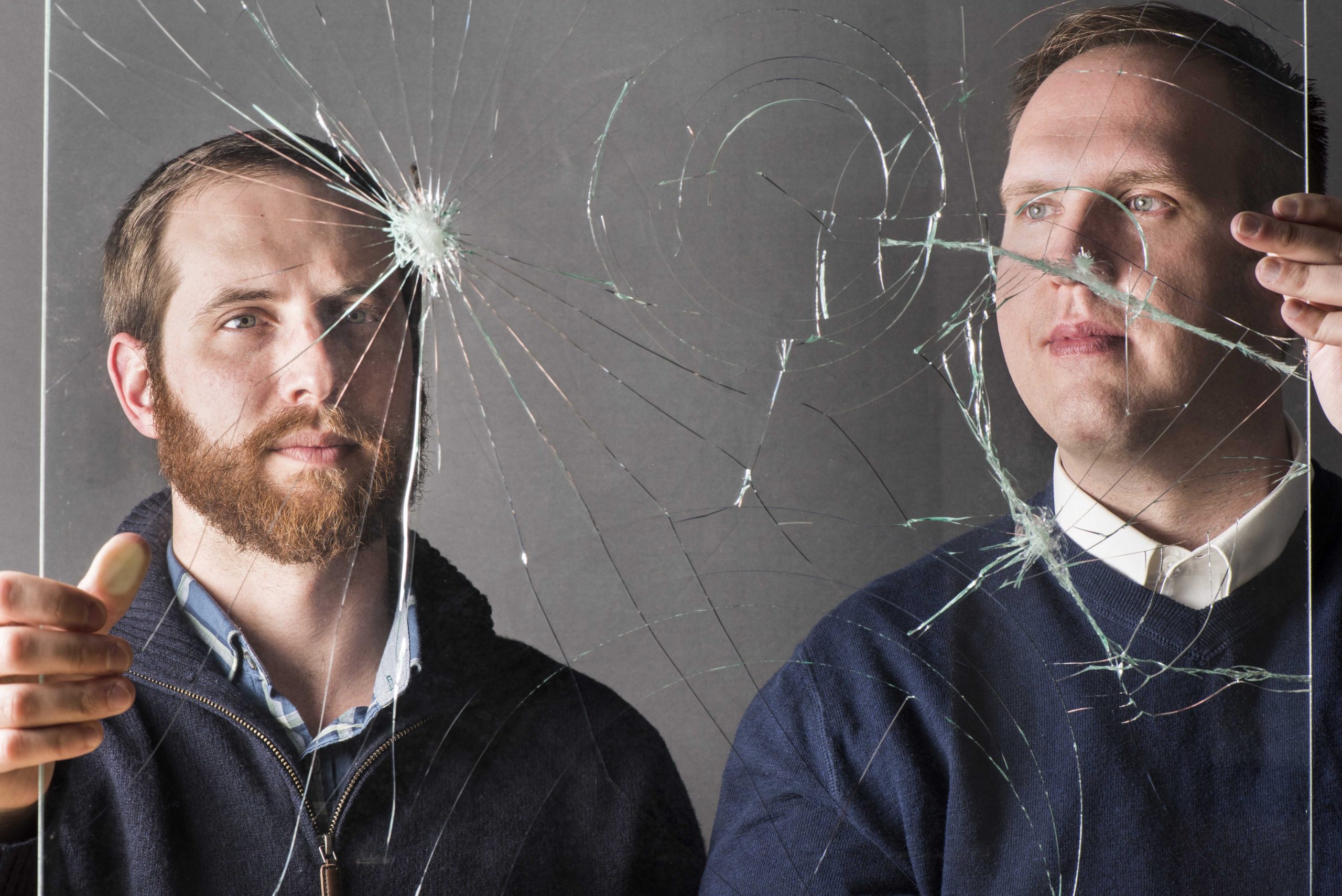 Sandia National Laboratories' Brenton Elisberg, left, and Ryan Jamison look at a piece of cracked laminate glass, an example of how brittle materials can fail. The two researchers are part of Sandia's Brittle Materials Assurance Prediction Program, aimed at a better scientific understanding of such materials.