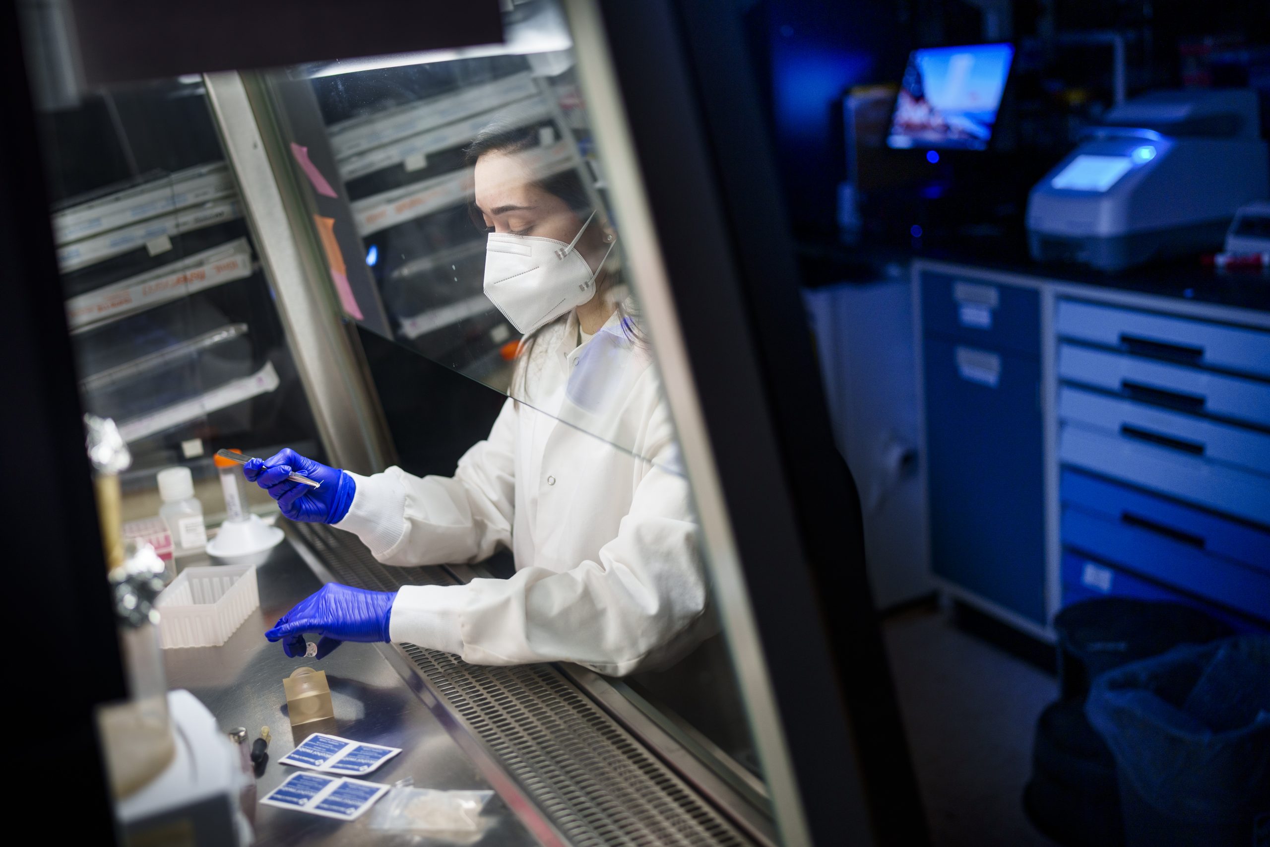 Brittany Humphrey prepares microneedles in a fume hood at Sandia National Laboratories.