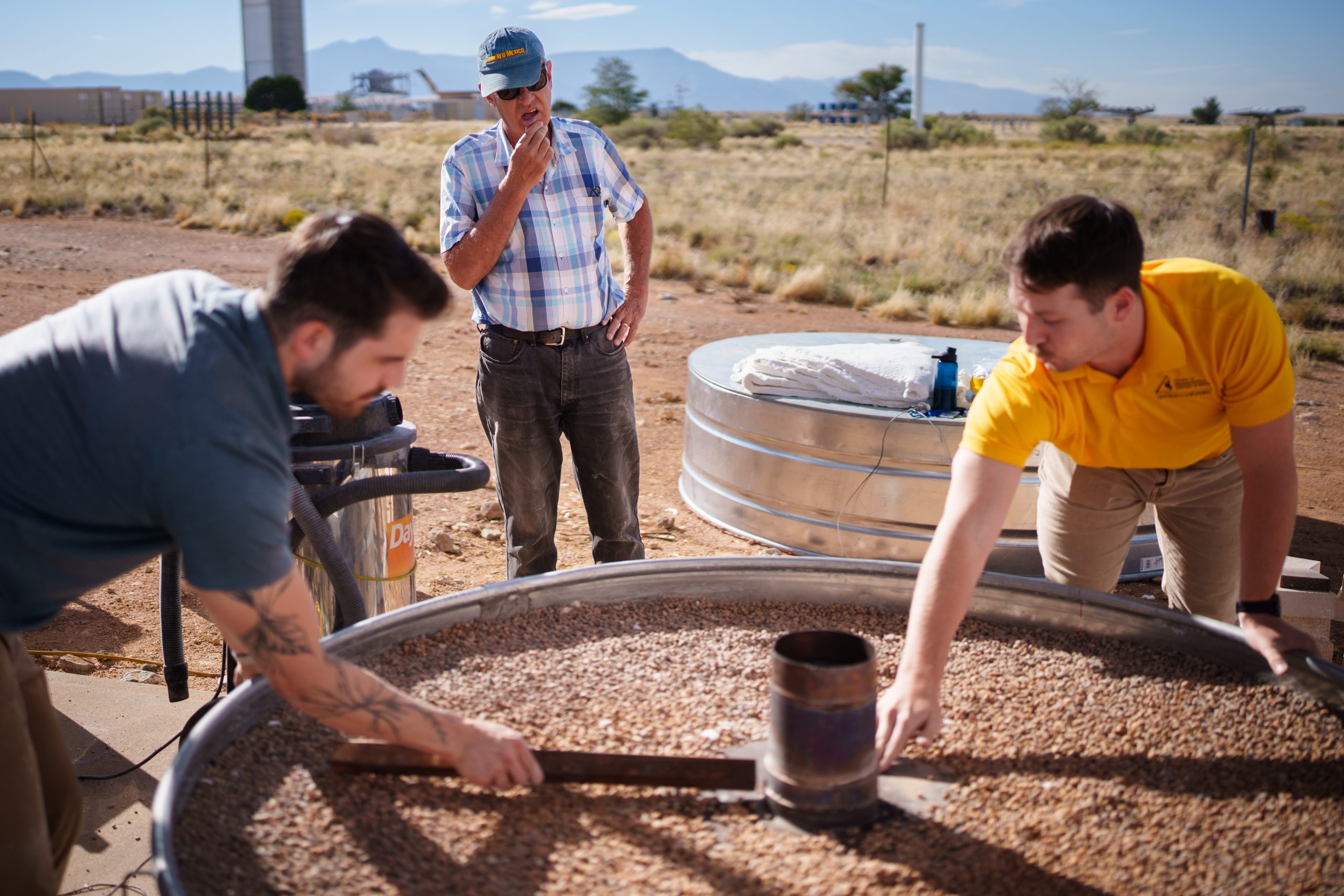 Sandia National Laboratories mechanical engineers Nathan Schroeder, left, and Luke McLaughlin, right, discuss the design of a thermal energy storage system with CSolPower co-founder Walter Gerstle, center. Sandia is testing CSolPower’s thermal energy storage system at the National Solar Thermal Test Facility.