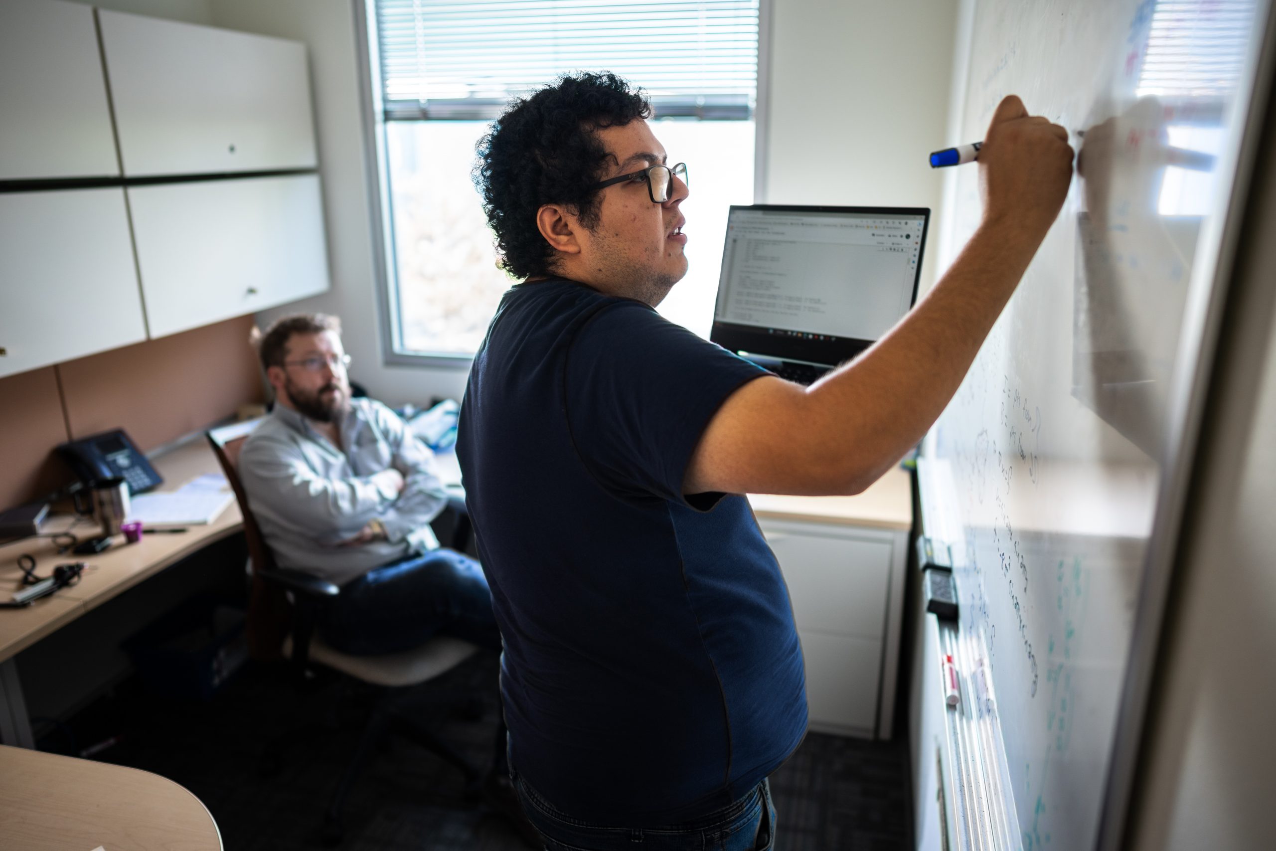 Doctoral candidate Arturo Rodriguez, center, works with mentor Nat Trask on machine learning using satellite imagery to predict ice sheet movement. They are part of the Rio Grande Consortium for Advanced Research on Exascale Simulation mentorship program.