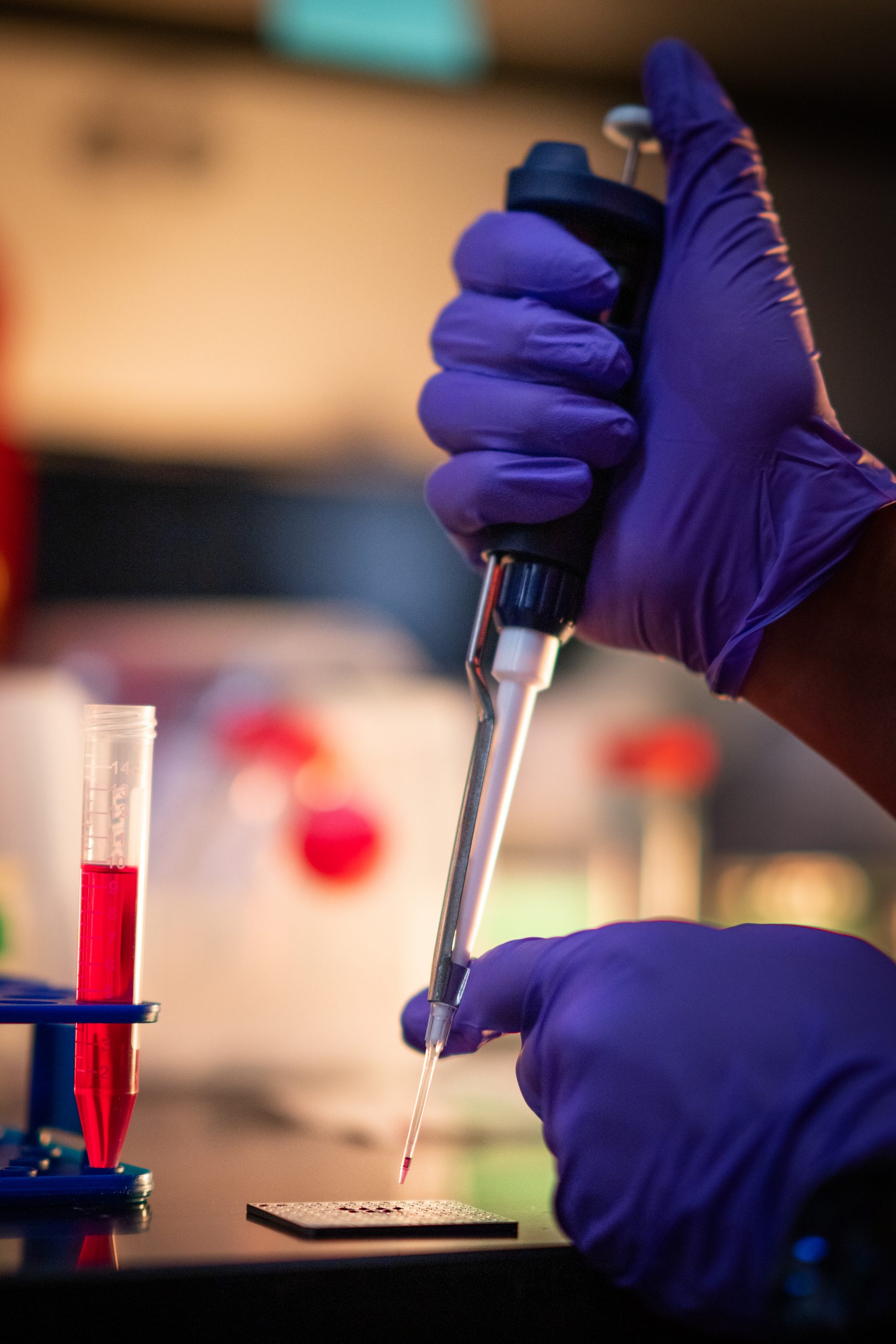 Andre Benally pipettes on a MALDI plate while working at Sandia National Laboratories as his team works to perfect its process for removing PFAS contamination.