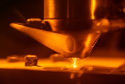 3D-printing technologies like Laser Engineered Net Shaping, shown here, are helping scientists at Sandia National Laboratories rapidly discover, prototype and test new materials.