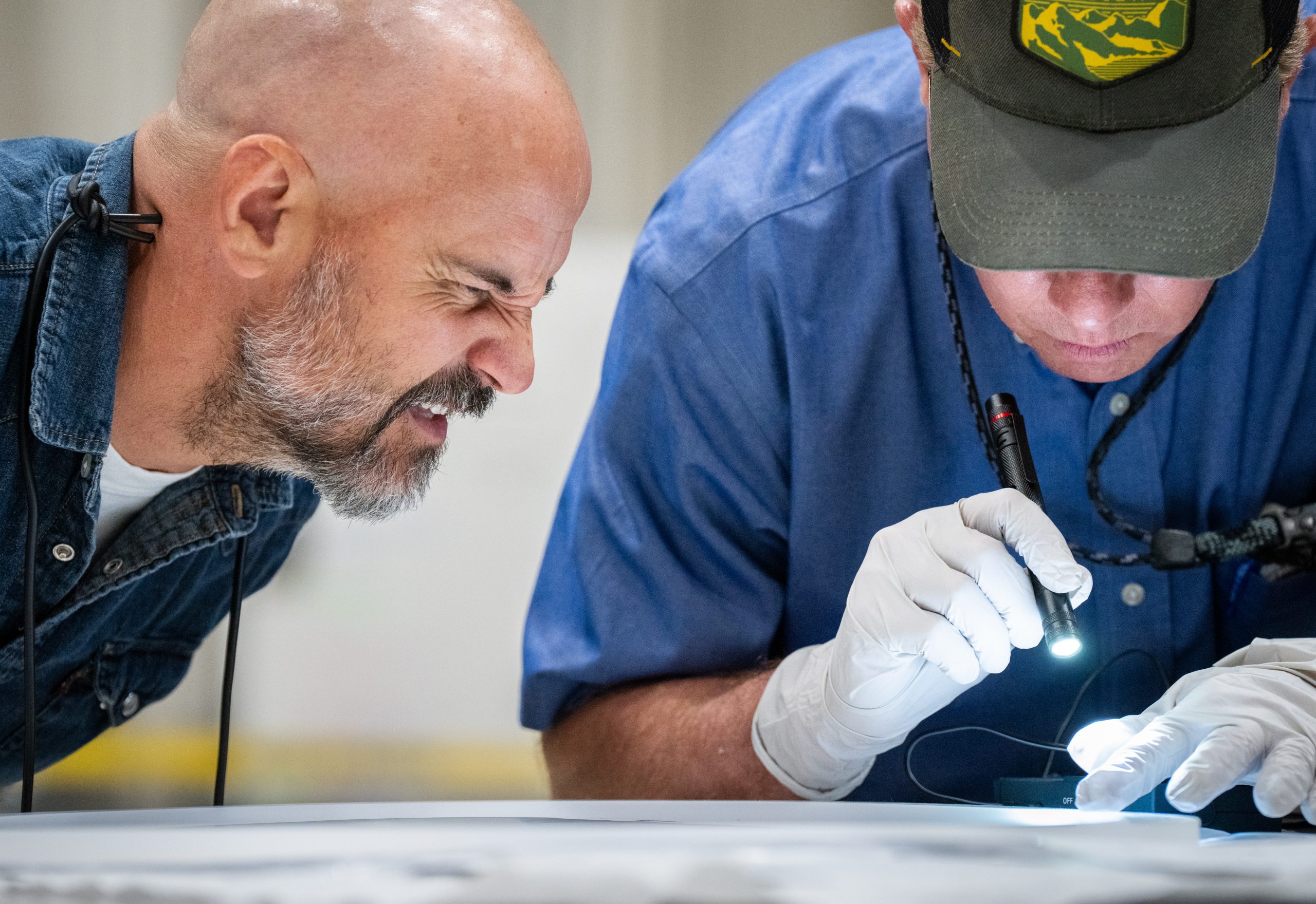 An inductive voltage-adder insulator ring is being inspected for defects that could cause cell failure. After passing inspection, it will be assembled into a cell.