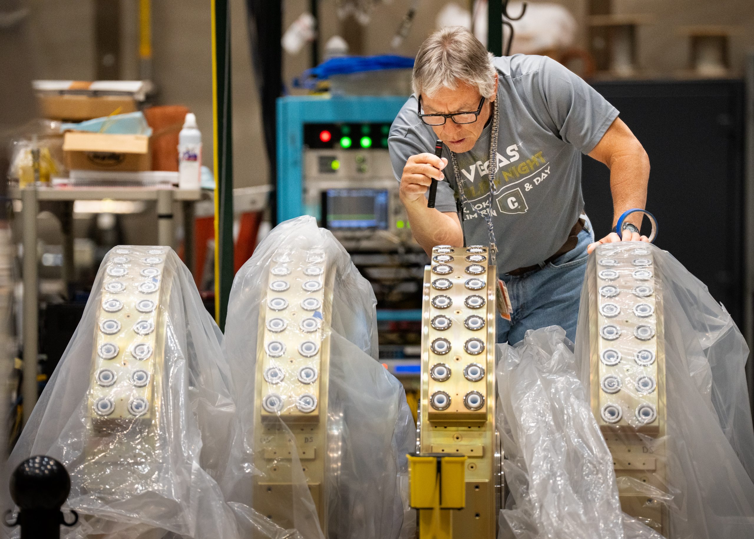 The 20 high-voltage connectors on an inductive voltage-adder cell are checked for assembly defects before moving the cell to electrical testing.