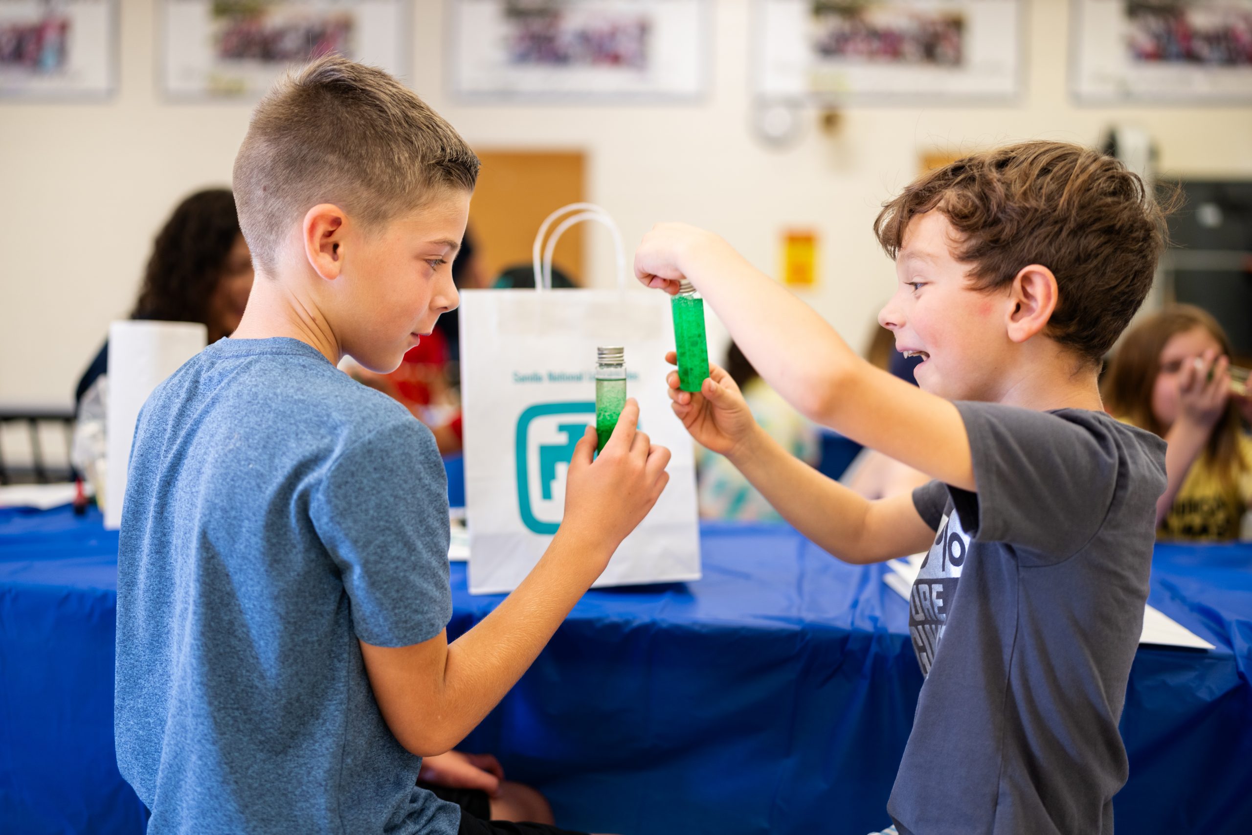 Quinn Fetman, 8, left, and Edward Ortega, 7, make miniature lava lamps during a Sandia National Laboratories STEM in the Sun event at Griegos Elementary School on July 26, 2023.