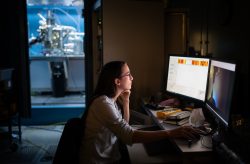 Postdoctoral researcher Caitlin McCowan inspects pieces of silicon at the atomic level. She uses a scanning tunneling microscope to spot imperfections as part of a quantum research project at Sandia National Laboratories.