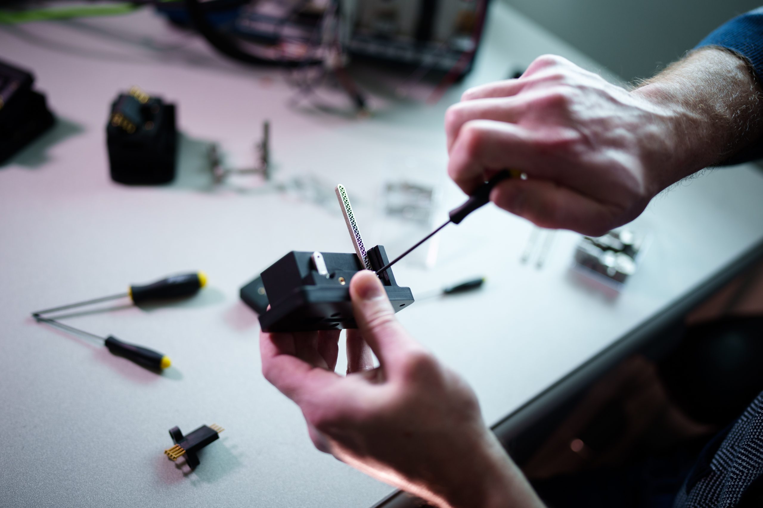 Sandia National Laboratories systems engineer Robert Petterborg assembles a newly designed cable connector that’s simple to use — so simple, he says it’s impossible to use wrong.
