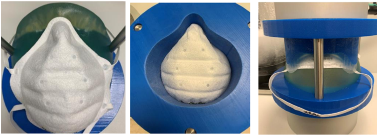 One of the first versions created by the team to test performance of a mask on a human face. The testing device drops down and compresses the mask with 50psi.