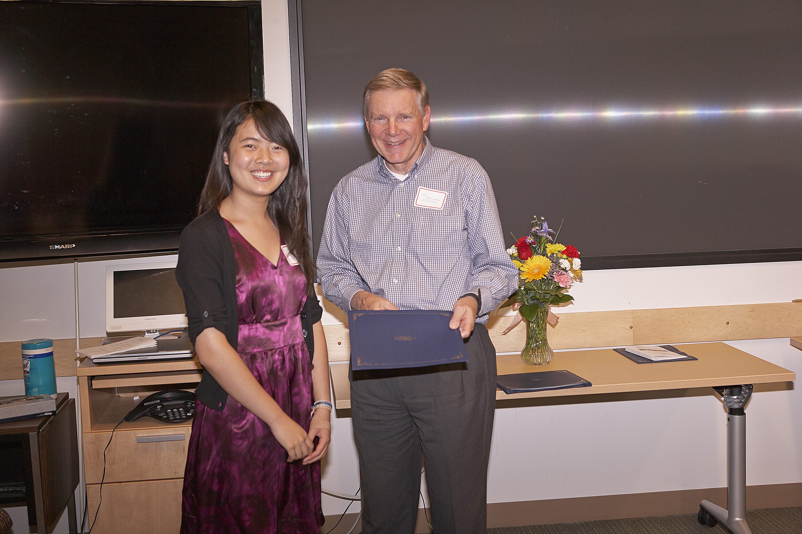 Christine Xu, a student at Amador Valley High School, receives an award from Sandia National Laboratories' Bob Carling in the science category. The annual Math and Science Awards are sponsored by the Sandia Women's Connection.