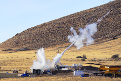 A test B61-12 nose assembly fired from Sandia National Laboratories’ Davis gun splashes water from an 8-foot-deep pool as a 2,000-pound reaction mass sails into the air from the other end of the gun in a successful impact test at New Mexico Tech’s Energetic Materials Research & Testing Center. The reaction mass eliminates the recoil load in the gun chassis during firing.