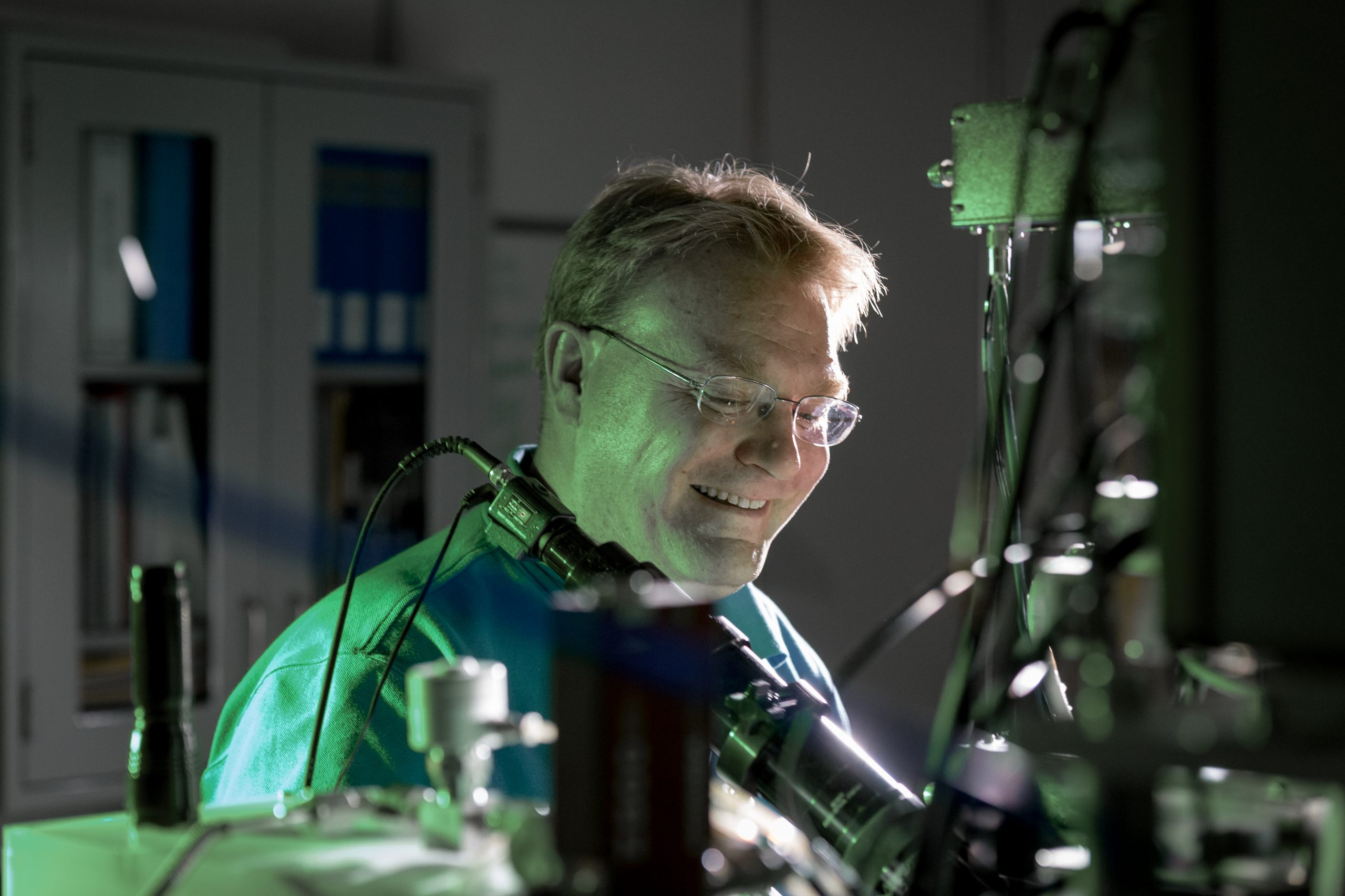 Sandia National Laboratories' Ed Bielejec examines a material at the Ion Beam Laboratory with the Nano-Implanter, a machine that produces very precise material defects. A smaller, lower voltage version will enable Bielejec and his team to do the same for advanced materials that could be used in semiconductors and other applications.