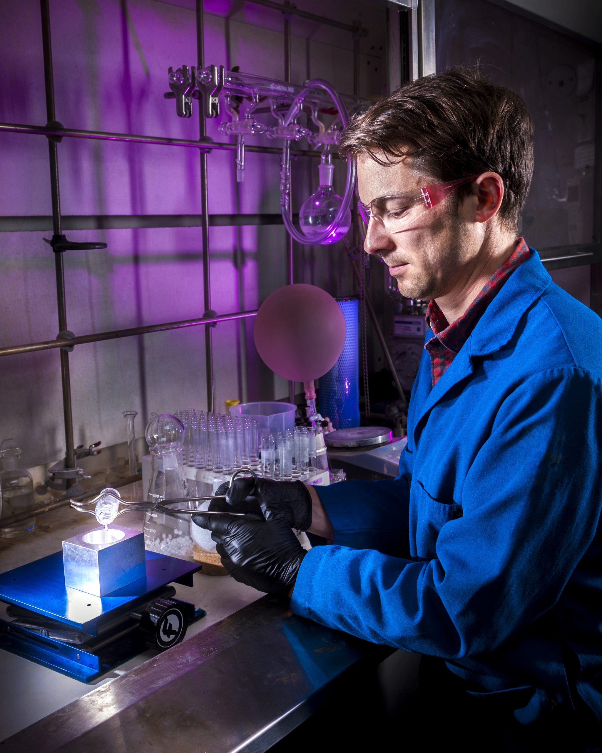 Sandia National Laboratories researcher Joey Carlson demonstrates the ease of casting an organic glass scintillator, which takes only a few minutes as compared to growing a trans-stilbene crystal, which can take several months.