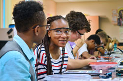 HMTech students wait for materials for an electronics and soldering project.  