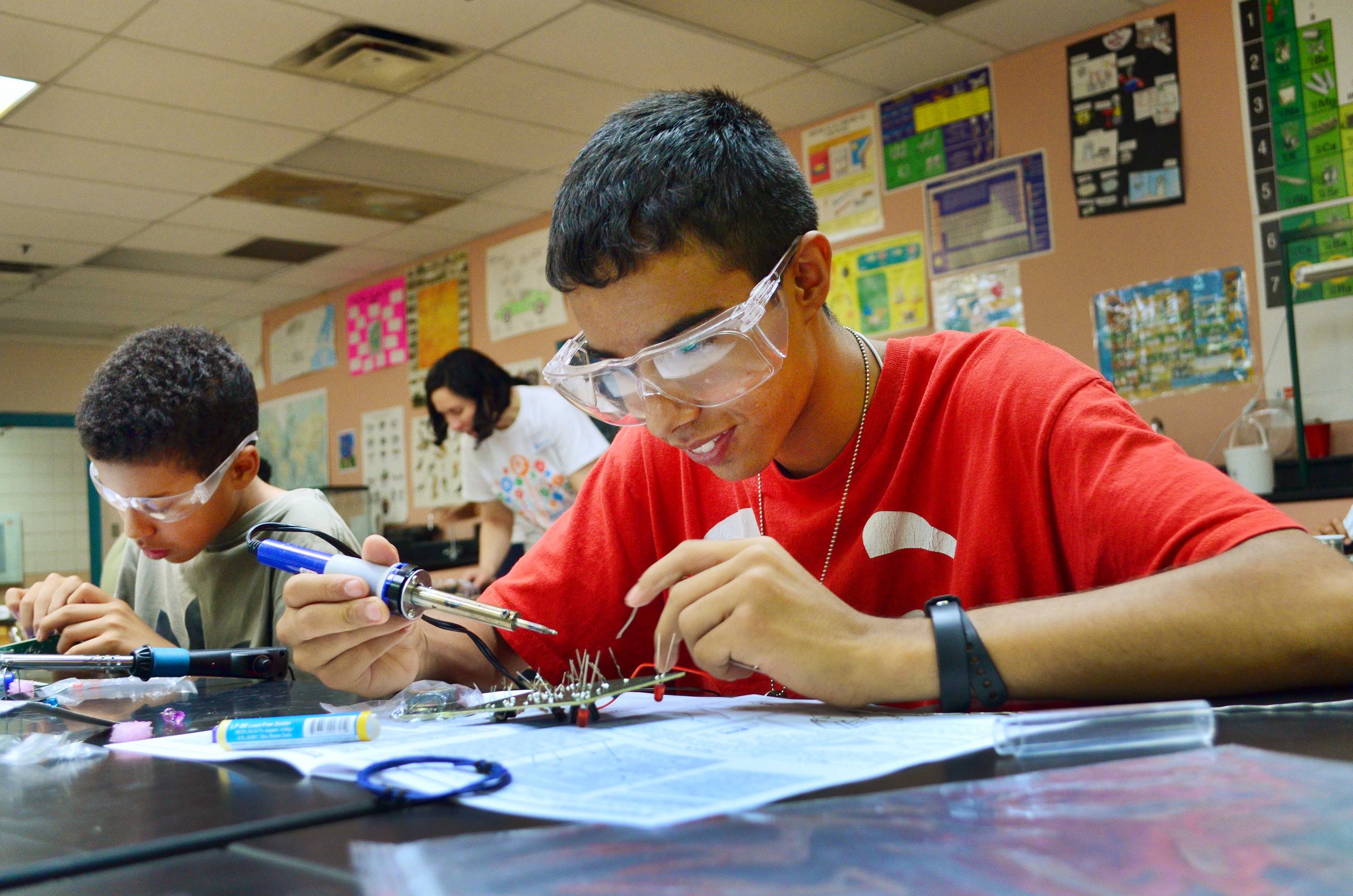 Students solder during an HMTech class. The program sponsored by Sandia National Laboratories’ Black Leadership Committee was developed to inspire African-American students to pursue STEM careers.