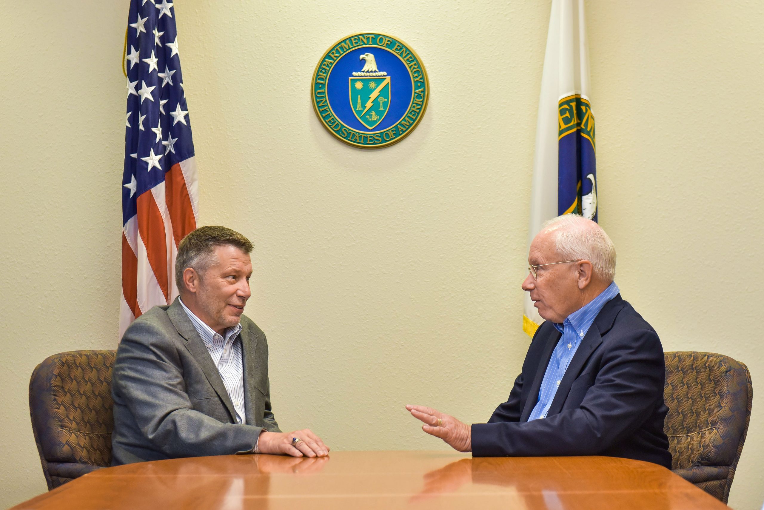 Jeff Harrell, left, manager of the National Nuclear Security Administration’s Sandia Field Office, and Steve Younger, the new director of Sandia National Laboratories, discuss Sandia’s transition to a new management and operating contractor. Younger assumed the labs’ top position on Monday.