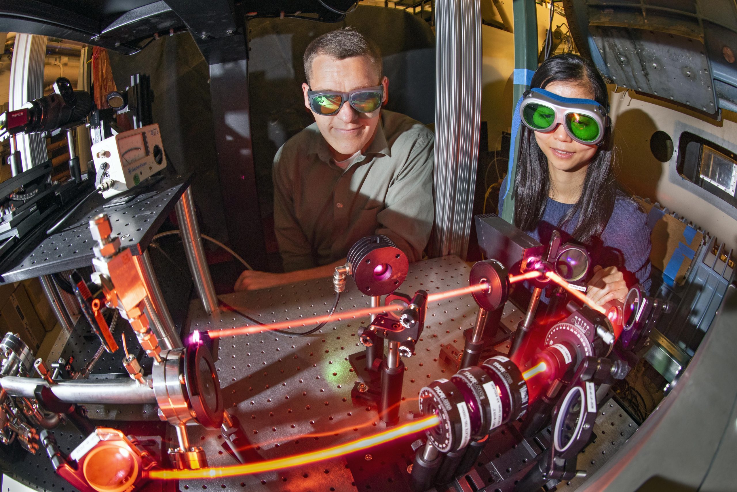 Daniel Richardson, left, a mechanical engineer in Sandia National Laboratories’ diagnostic sciences, and Yibin Zhang, a postdoctoral fellow, observe a laser that records measurements in the hypersonic wind tunnel.
