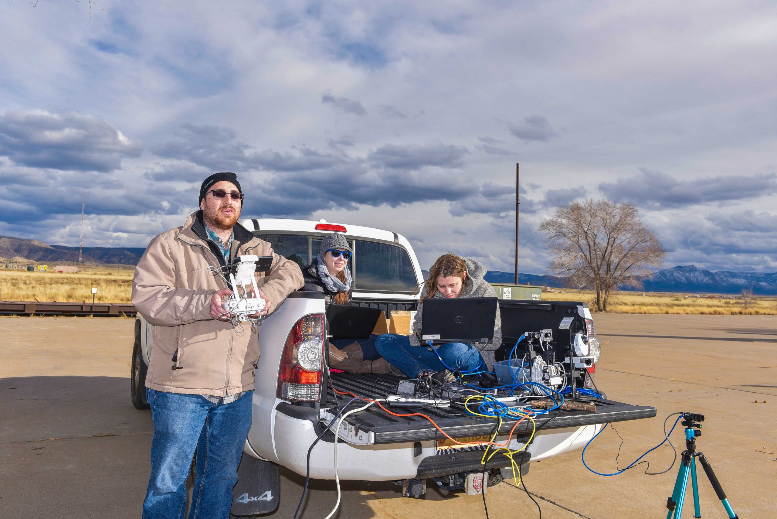 Camron Kouhestani, left, flies an unmanned aircraft system while Jaclynn Stubbs, center, and Bryana Woo monitor a camera stream at Sandia National Laboratories. Some labs research involving unmanned aircraft systems encompasses using a swarm of drones to track and capture enemy aircraft systems while they fly.