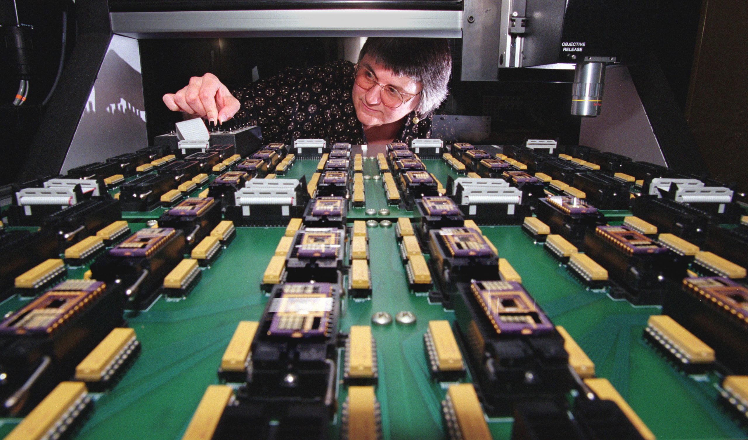 In a 1998 photo, Sandia National Laboratories’ Danelle Tanner tests microelectromechanical system reliability using the one-of-a-kind Sandia High-volume Micromachine Measurement of Reliability, or SHiMMER, instrument. MEMS, complex machines with micron-size features, are so small they are imperceptible to the human eye and have moving parts no bigger than a grain of pollen.