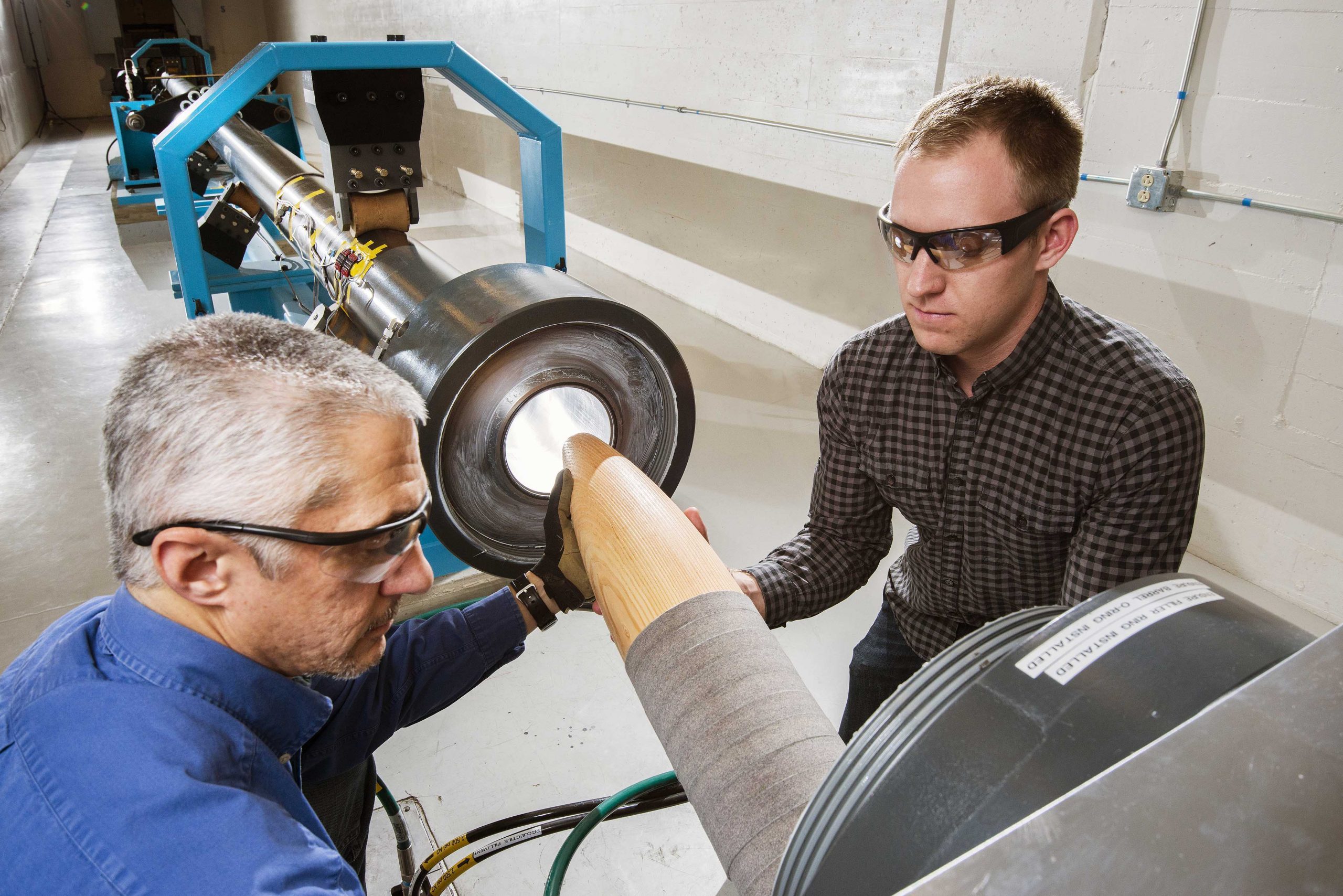 The Mechanical Shock Facility is Sandia's oldest environmental test facility. The construction team added a six-inch bore gas gun, seen here with researchers Adam Slavin, left, and Patrick Barnes.