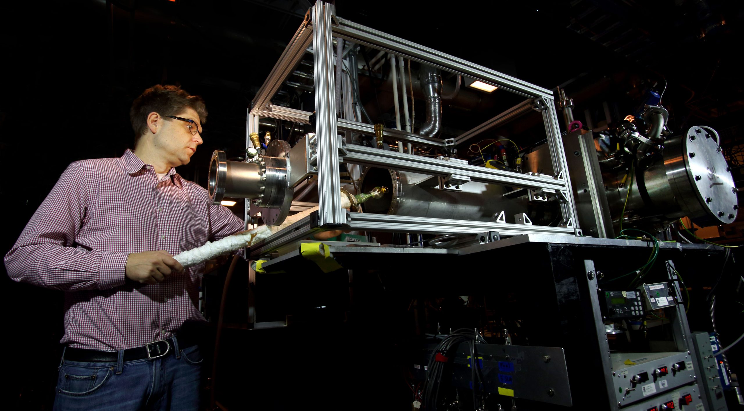 Sandia National Laboratories researcher Nils Hansen uses a device called a jet-stirred reactor to conduct chemical research that adds to the fundamental knowledge of combustion.