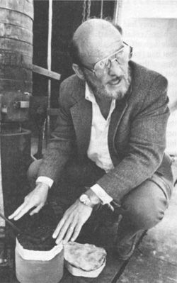 Paul Cooper, in a 1990 photo published in the Sandia Lab News on the USS Iowa investigation, explains the half-scale test apparatus used for impact-ignition experiments.