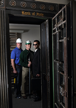 Sandia National Laboratories managers Alex Roesler, left, and Luke Purvis, center, and systems analyst Jarret Lafleur shown inside a Bank of Italy vault in a historic Livermore, California, building, studied 23 high-value heists that occurred in the last three decades for lessons learned that can applied to designing complex security systems to protect vital national security assets.