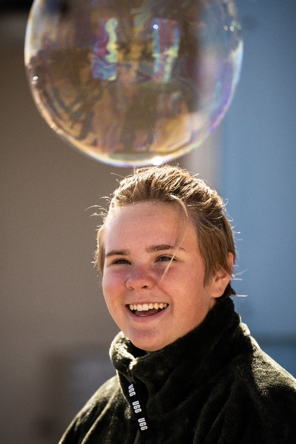 Student Elizabeth Titus, daughter of manager Paul Titus, makes a bubble while taking part in Kids Day at Sandia National Laboratories.
