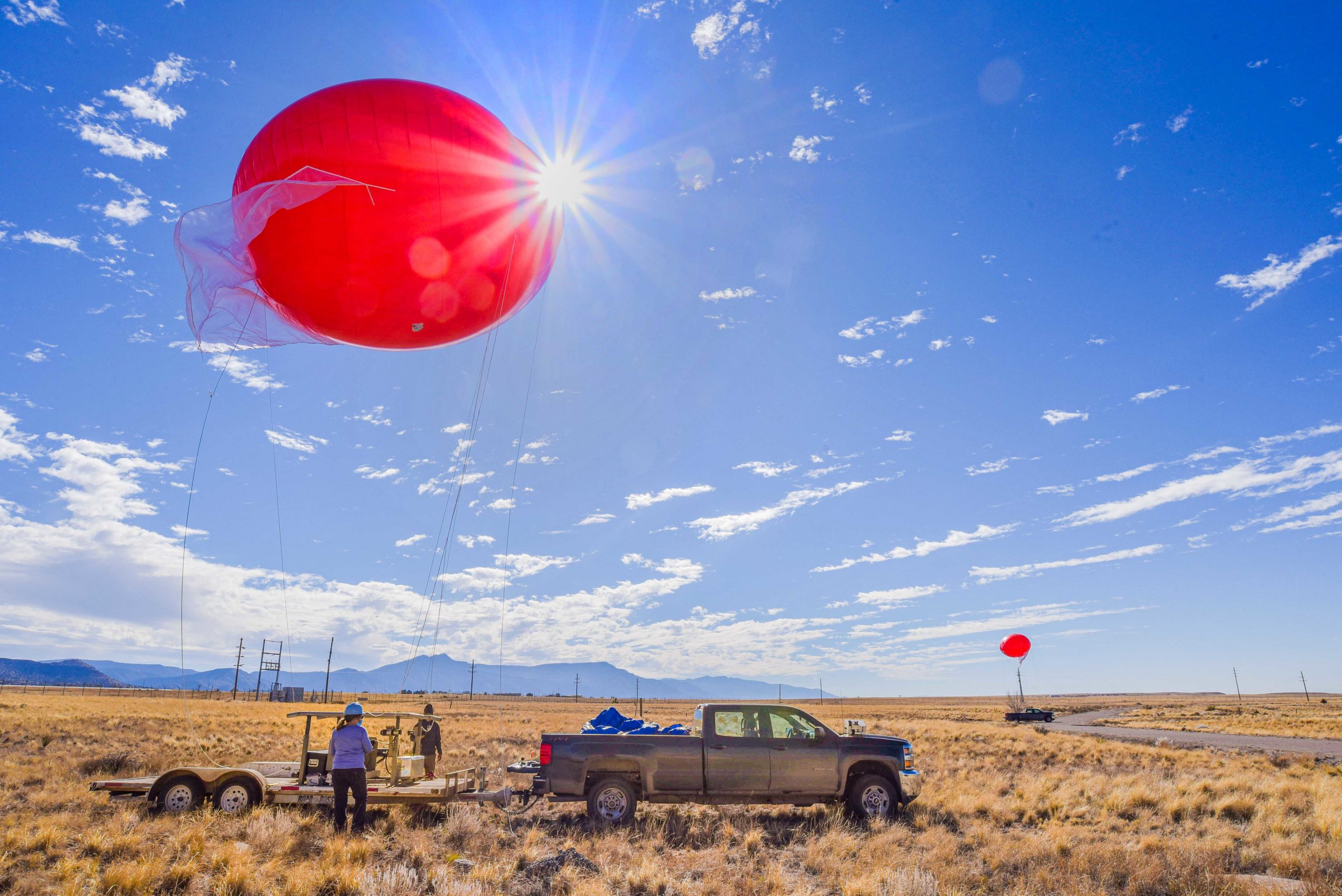 Dari Dexheimer, Sandia National Laboratories’ tethered-balloon expert, and her team prepare the 22-foot-wide, tethered, helium balloons for launch on a gorgeous fall morning.