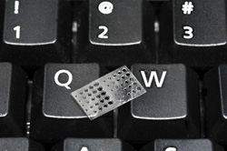 This tiny test structure was fabricated from the same photo-crosslinkable PDMS material which has been implanted into rats as part of the MD Anderson Cancer Center-UNM-Sandia collaboration. The test structure helps researchers characterize the performance of their microprojection lithography system.