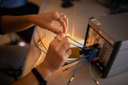 A firmware developer works with a toolbox-sized prototype for a software-defined system called Multi-Mission Radio Frequency Architecture.