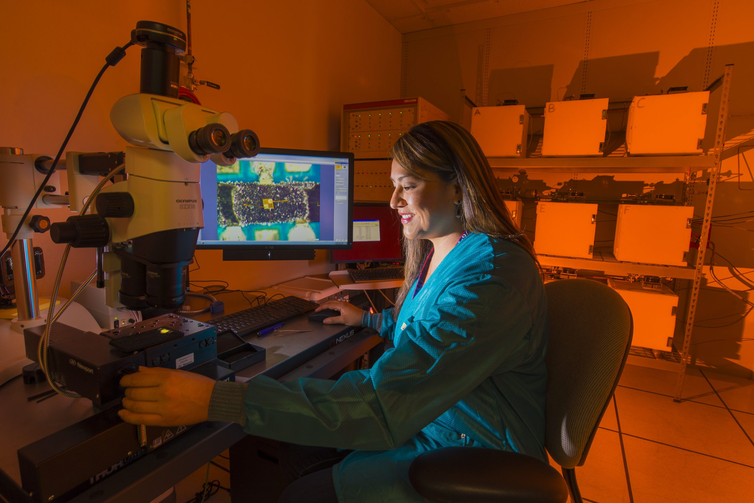 Sandia National Laboratories researcher Rachelle Thompson inspects an electronic device that's part of a 30-year Sandia program to look at how environments, including radiation from a nuclear weapon itself, could affect the performance of electronics inside a W76-1 warhead. The study begun in 2006 will provide real-time data for the first time on how electronics age within a weapon.