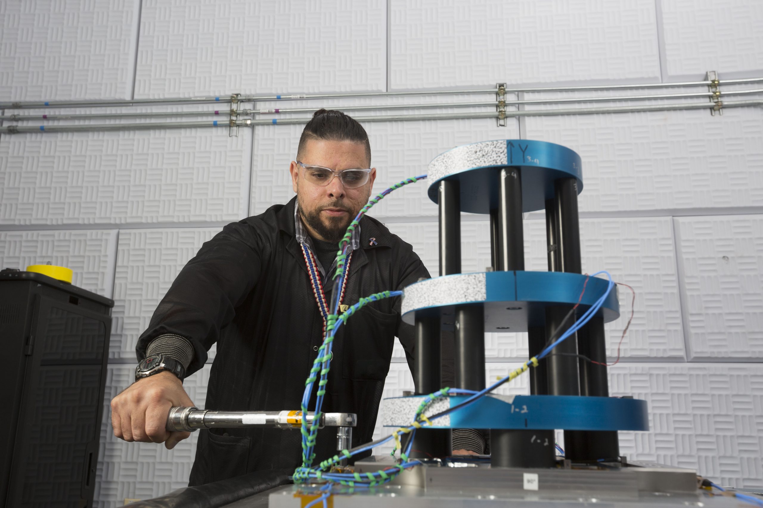 Ralph Lied-Lopez, Sandia National Laboratories technologist, helped to study the amount of vibration that mechanical objects endure in flight, including the so-called “wedding cake” seen here.