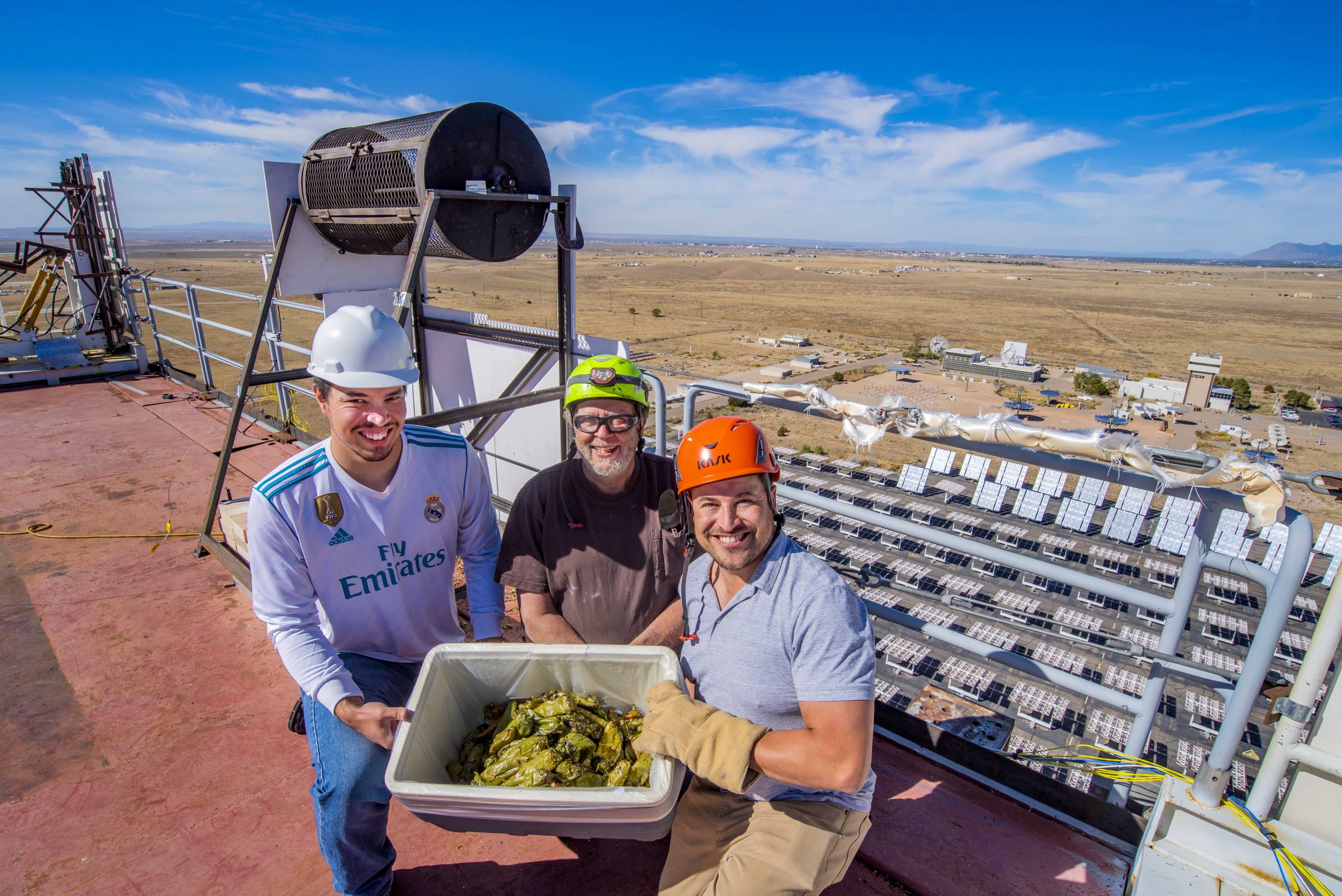 From left to right, Aaron Overacker, a Sandia National Laboratories intern, Daniel Ray, a technologist, and Ken Armijo, project lead, display solar-roasted green chile before surveying chile connoisseurs on their peel-ability, taste, texture and smell.