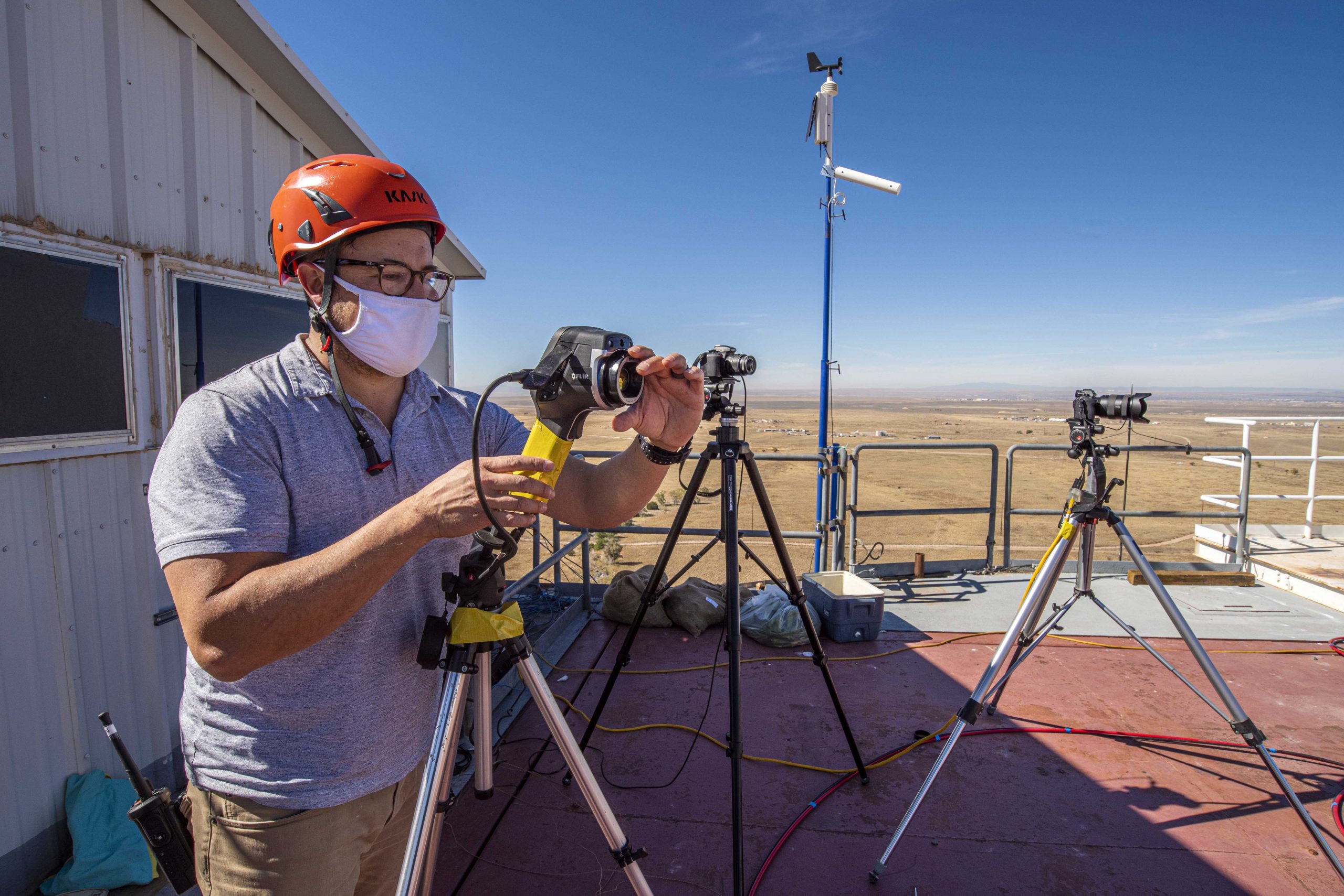 Sandia National Laboratories engineer Ken Armijo sets up a number of infrared cameras and data collection devices before the first-ever solar chile roast.