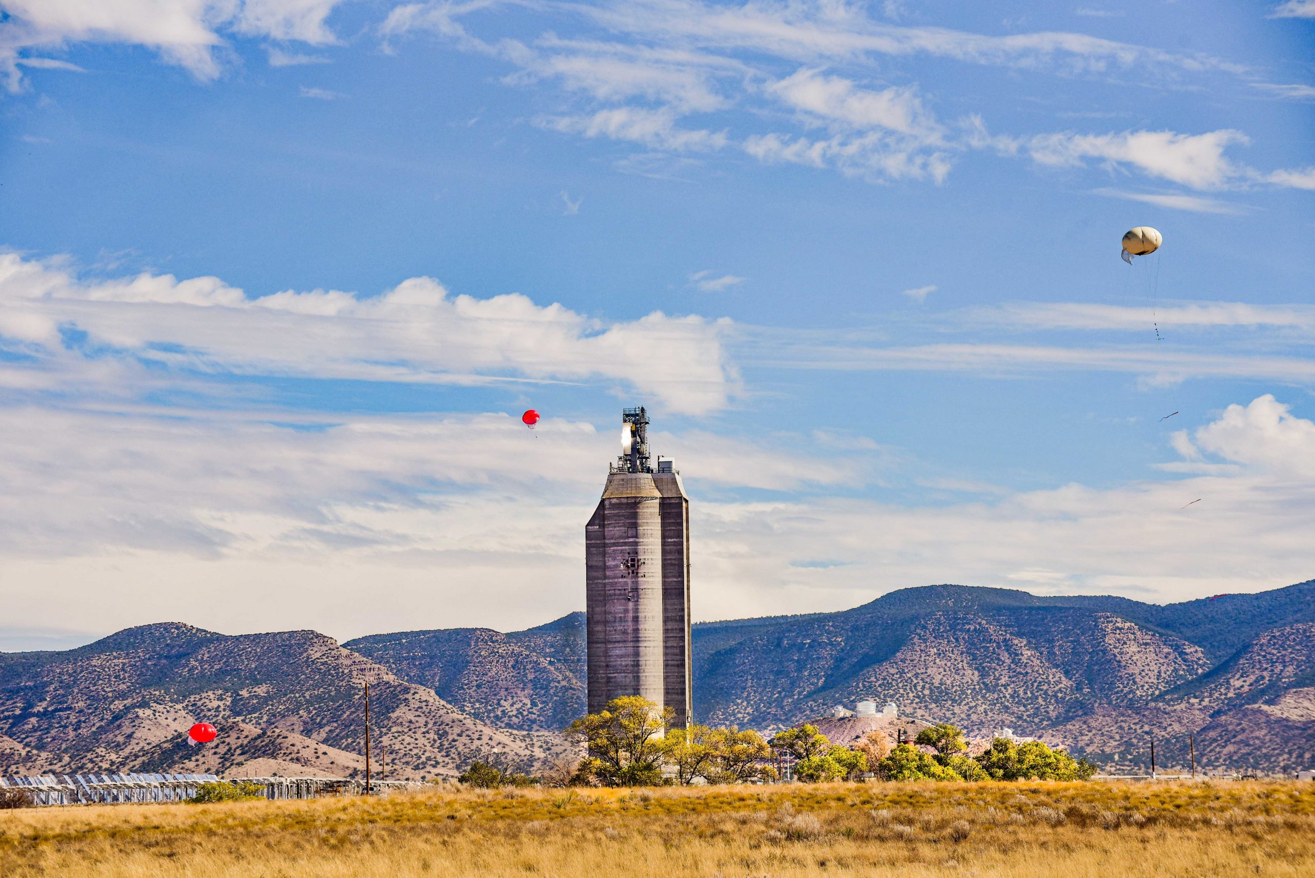 Three tethered balloons were deployed both upwind and downwind of Sandia National Laboratories' National Solar Thermal Test Facility during a falling-particle receiver test. The team, led by Cliff Ho, found that the concentration of tiny particles, finer than talcum powder, that escape from the receiver were much lower than Environmental Protection Agency limits.