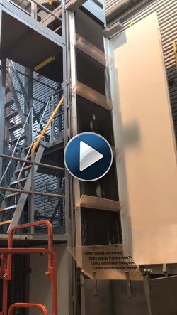 This stair-like system slows dark, sand-like ceramic particles as they fall through a beam of concentrated sunlight. The stair-like system reduces the impact of wind on the falling particles, mitigating the release of fine dust that can pose health hazards.
