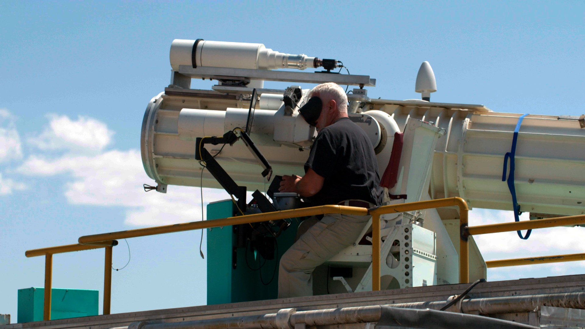 Jim Galli of Sandia National Laboratories' Tonopah Test Range tracks a test unit with a telescope during a test at the Nevada range. 