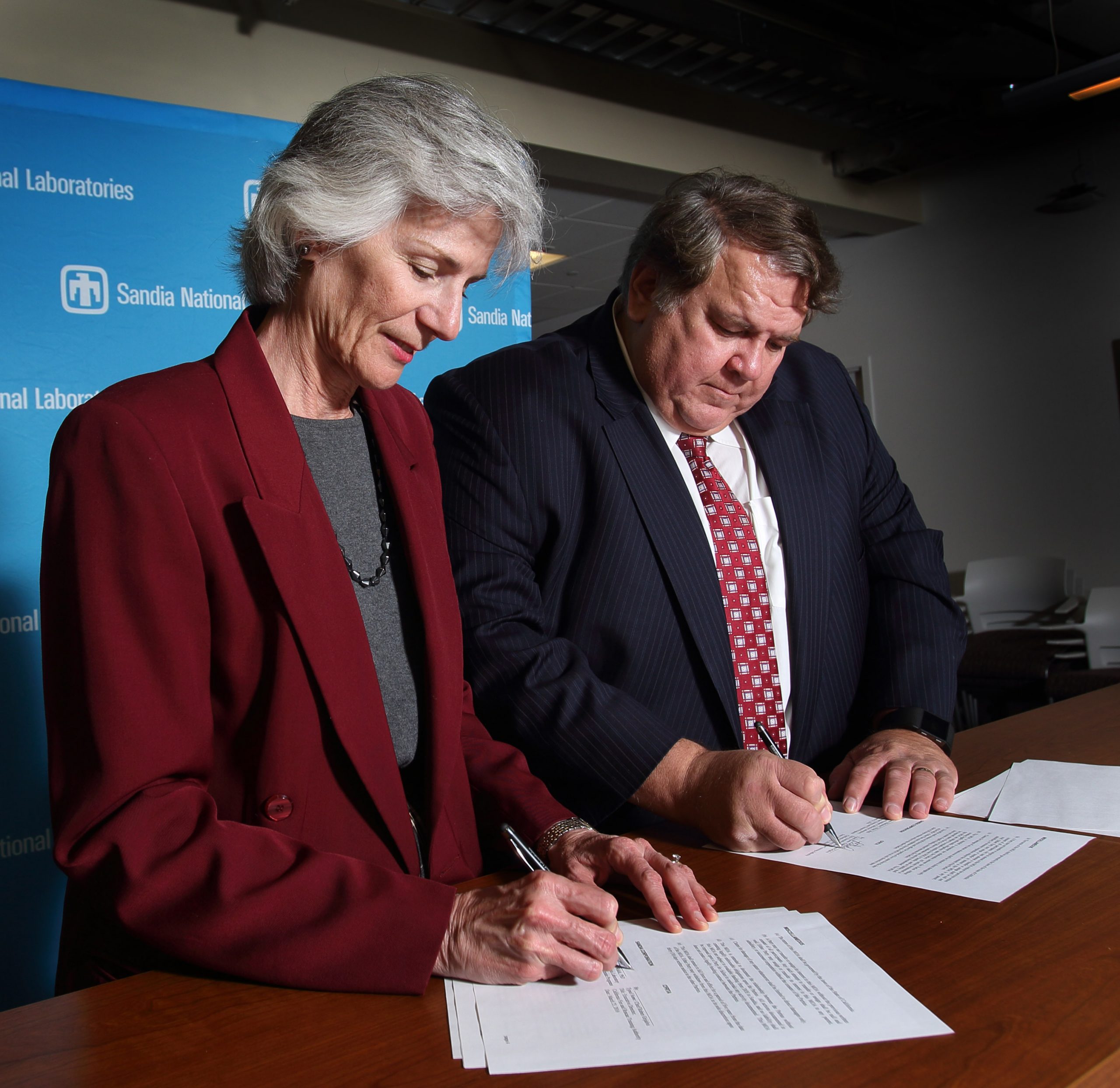 Marianne Walck, vice president of Sandia’s California site and the Energy & Climate program, and Ruben Grijalva, executive director of California Fire and Rescue Training Authority, sign a memo of agreement between the two entities.