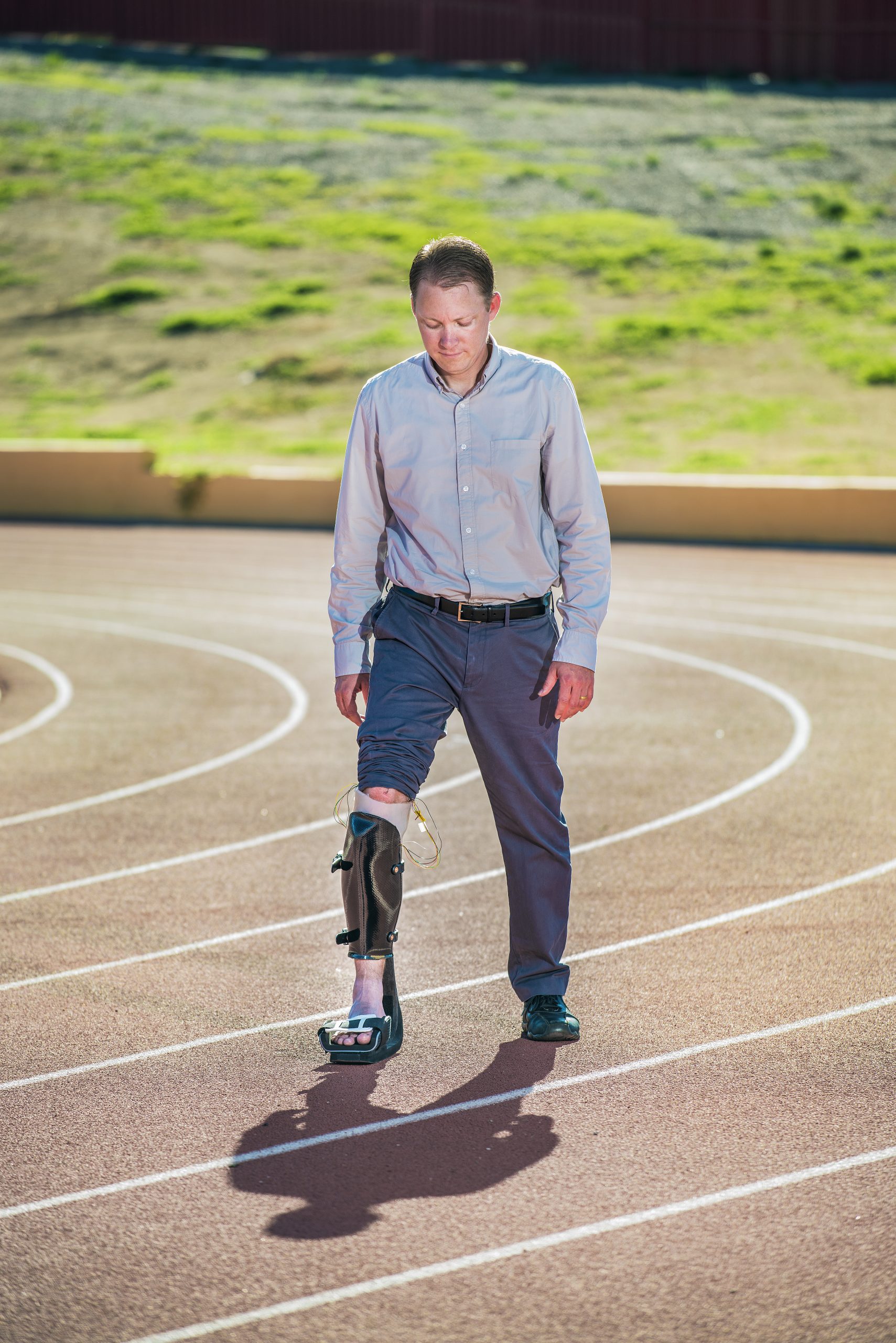 Sandia National Laboratories researcher Jason Wheeler demonstrates a special clamp-on socket with an artificial foot that helps him test a liner Sandia is developing for prosthetics. The two-piece socket shifts the load from Wheeler’s foot to his leg, giving him a better idea of what an amputee feels.