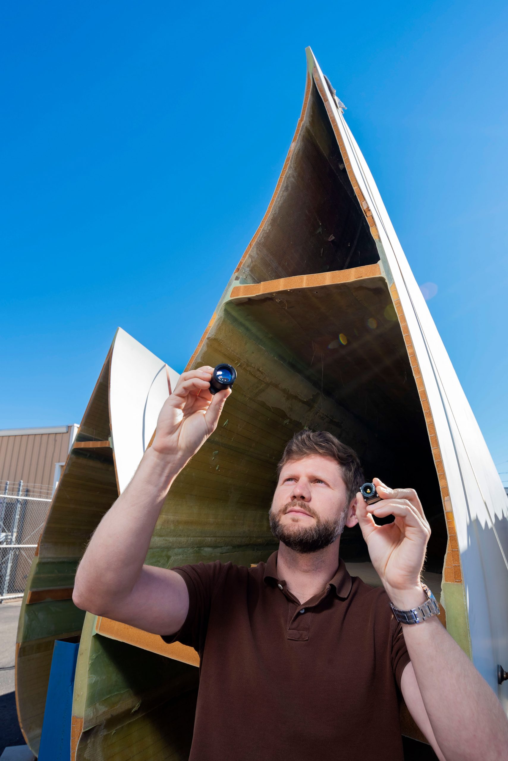 Ray Ely of Sandia National Laboratories inspects the cameras to be tested on drones that use thermography to detect hidden wind blade damage.