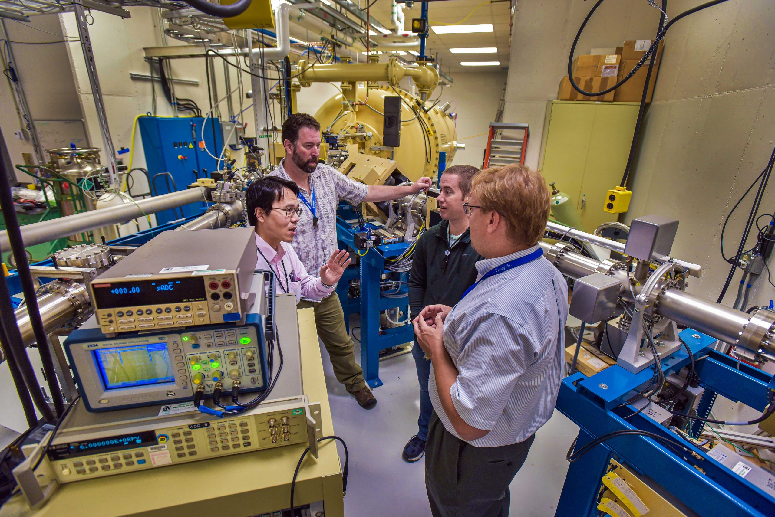 Sandia National Laboratories researchers, from left, Yuan-Yu Jau, George Burns, Justin Christensen and Ed Bielejec plan to test a future neutron generator for an electric-field imaging system at Sandia’s Ion Beam Laboratory, pictured here.