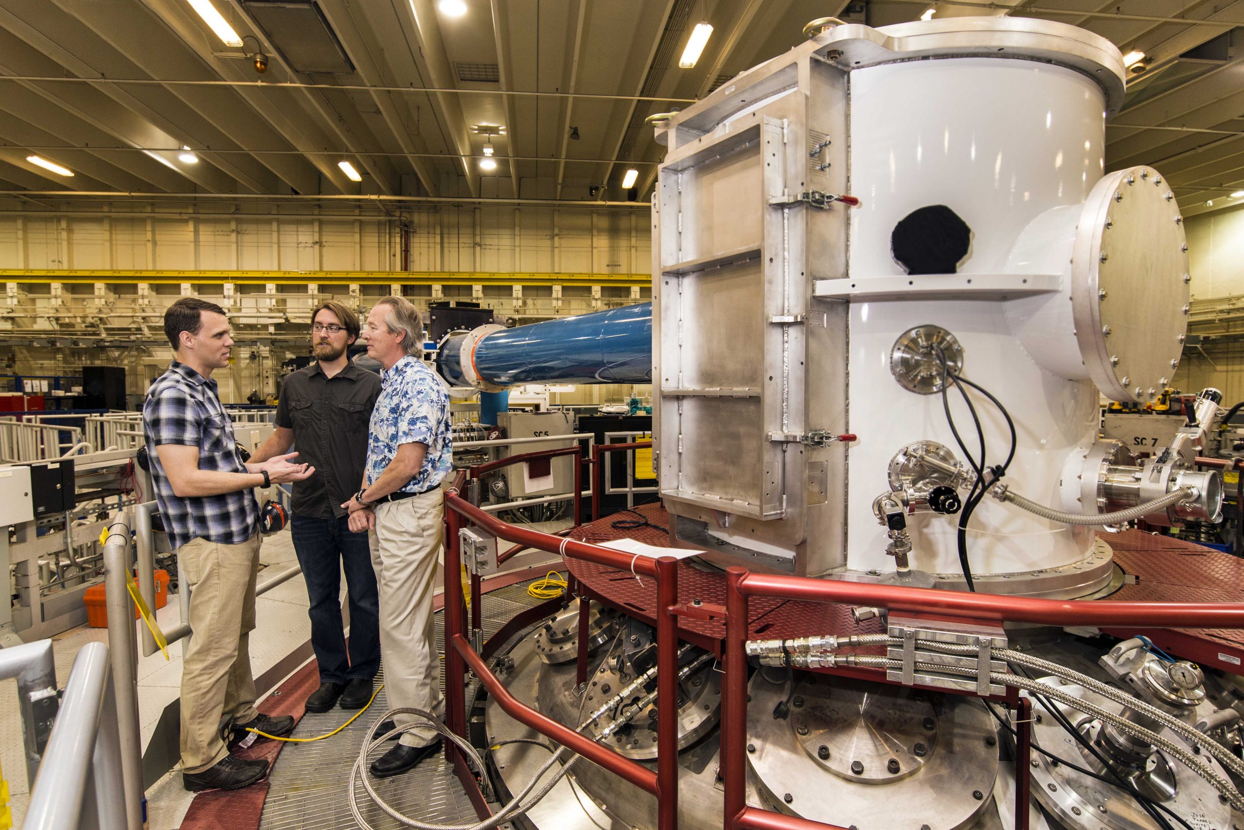 At the heart of Sandia National Laboratories' Z machine, Matt Gomez, left, presents an idea to Steve Slutz, right, while Adam Sefkow looks on.