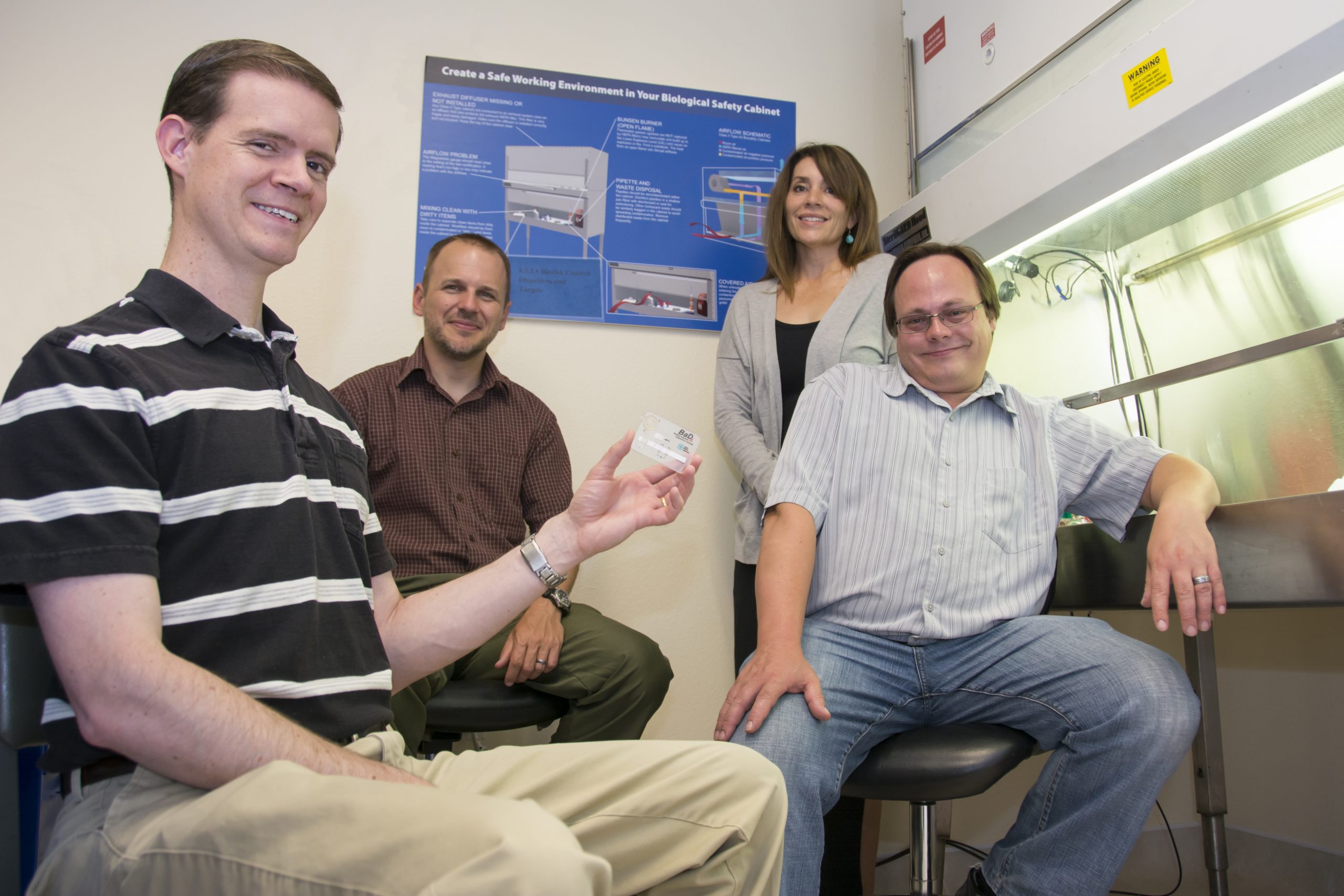 From left, Sandia National Laboratories team members Jason Harper, George Bachand, Melissa Finley and Bryan Carson. The group led invention of the anthrax detector held by Harper.