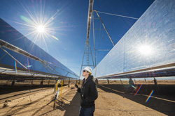 Steve Sellers of AREVA Solar stands amid the Compact Linear Fresnel Reflectors, the mirrors that focus sunlight to the top of the structure where molten salt is flowing. The resulting heat is stored and used later when the sun is not shining.